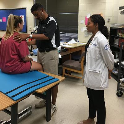 Executive Director Dr. Timothy Johnson performing sports physicals in Loudoun