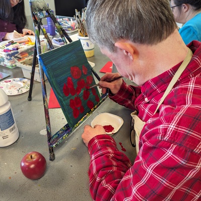 Spencer working in red paint