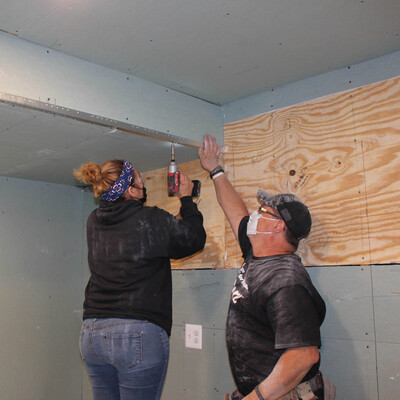 Sweat equity hours are required for future homeowners.  Working together to learn new skills.