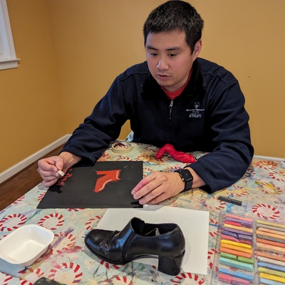 Ian learns about highlight and shadow while drawing a still life shoe in pastels