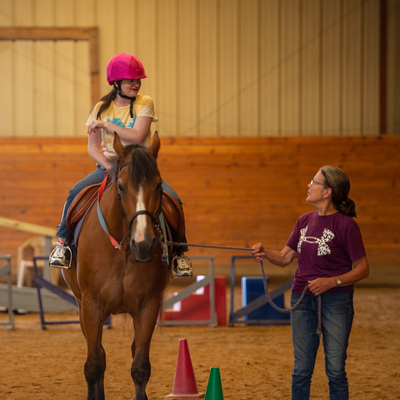 Volunteers work closely with participants and instructors to ensure a safe, productive riding experience!