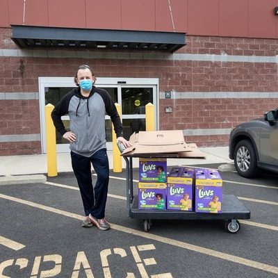 Board member Jerome Schlafer helping to replenish diapers at the warehouse