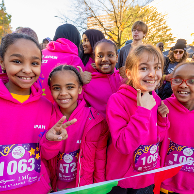 Girls on the Run participants excited to start the 5K as they wait at the starting line.