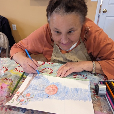 Regina fills in details of her apple pencil drawing