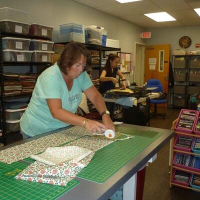 Volunteer cutting fabric