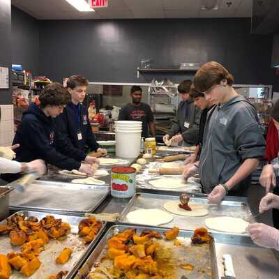 High Schoolers from Young Men Service League's Great Falls Chapter along with their moms cooked 400 meals for shelter donations in Dec 2023