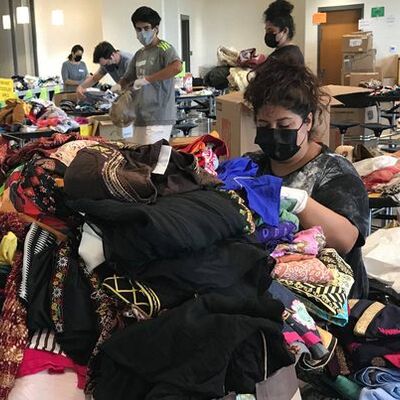 Sorting through clothing donated for Afghan evacuees at Lightridge High School September 2021.