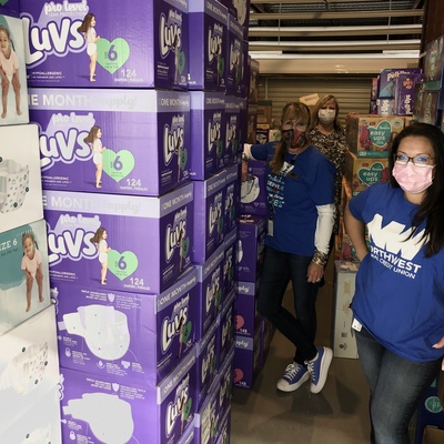 The wonderful staff & volunteers from the NWFCU Foundation helping to stock diapers in our warehouse