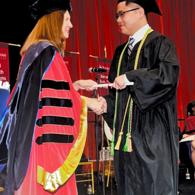 John Kwon, recipient of a Windy Hill education scholarship, receiving his diploma from SHU