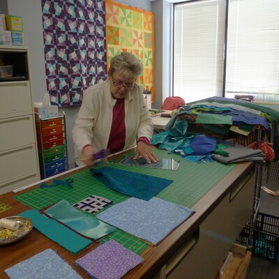 Volunteer cutting fabric