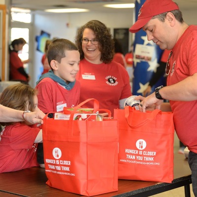 Families come together to volunteer at our Red Bag events.