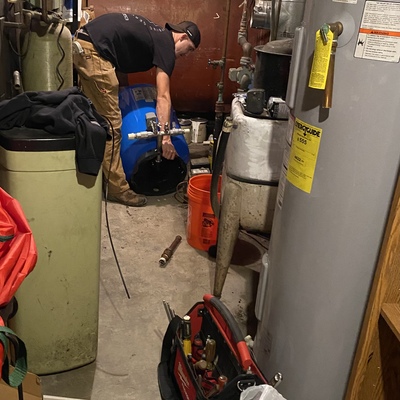 Lance from Diamond Plumbing repairing an elderly couple’s well system