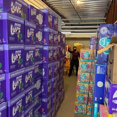 Jane Nash, volunteer, stacks diapers in the warehouse
